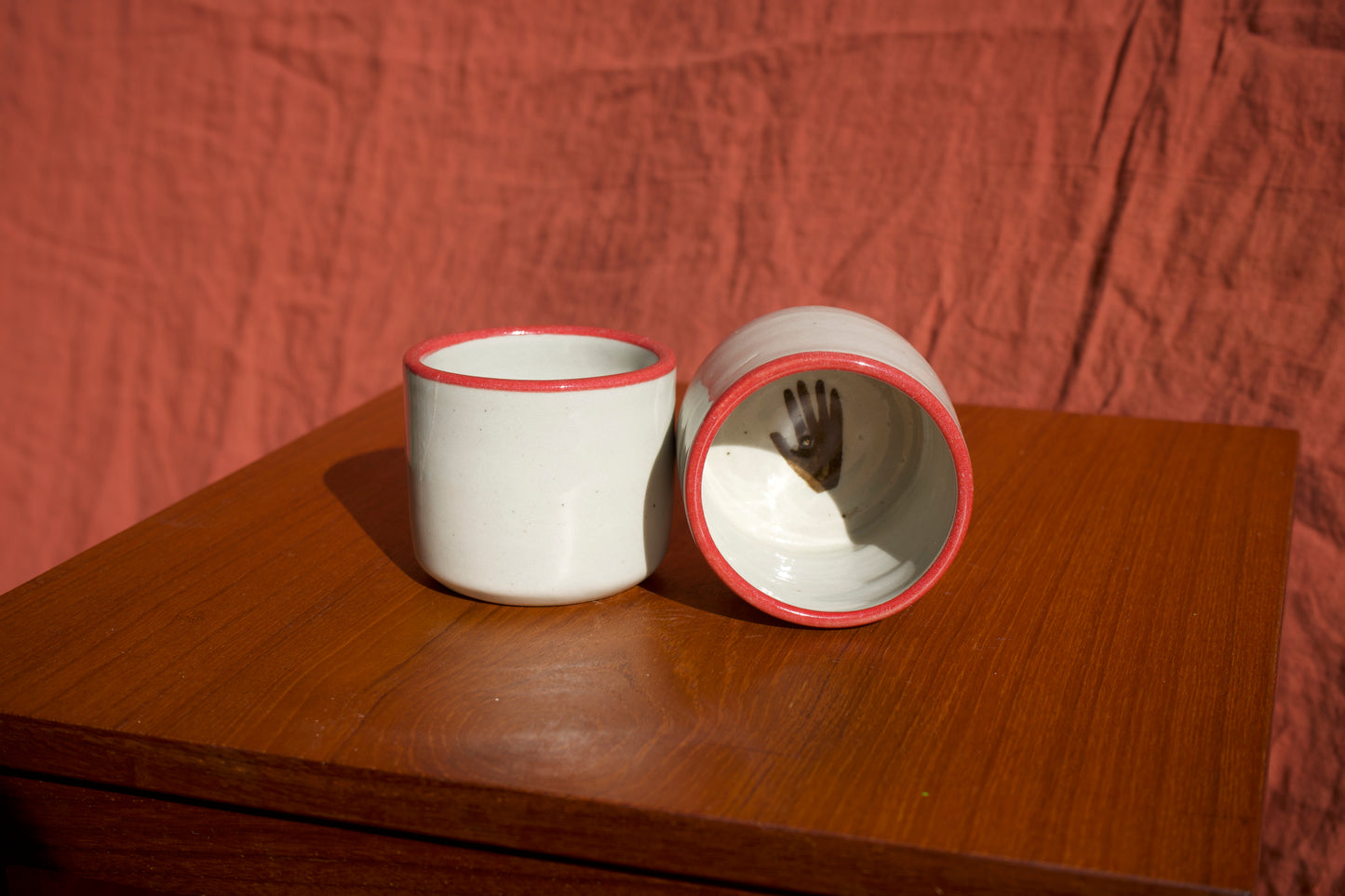 Red Rimmed Cups with Hand - Set of Two