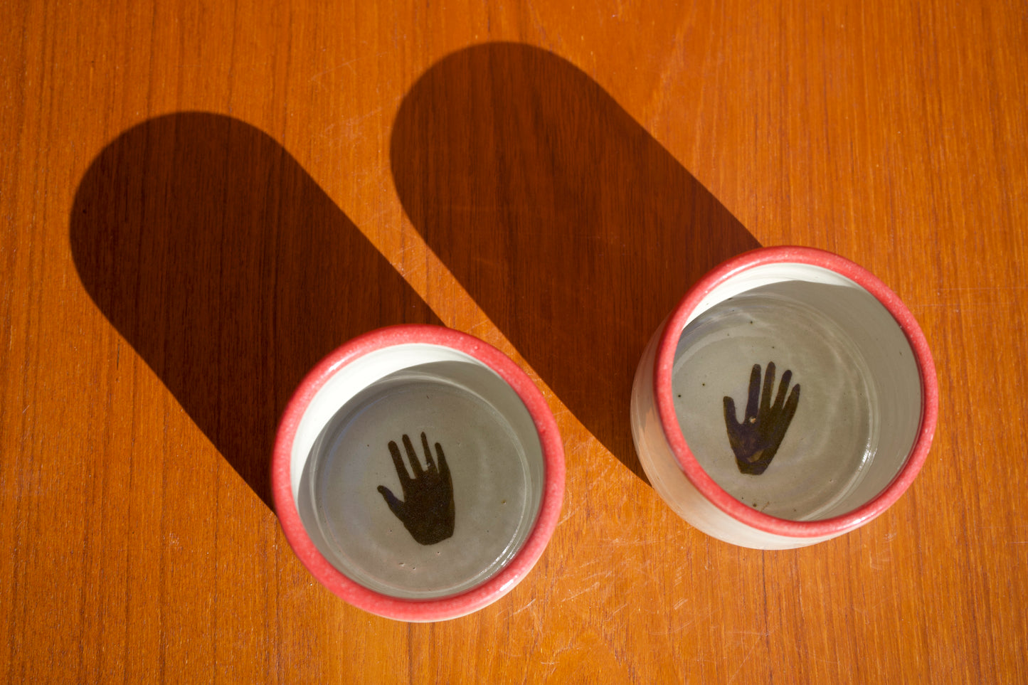 Red Rimmed Cups with Hand - Set of Two